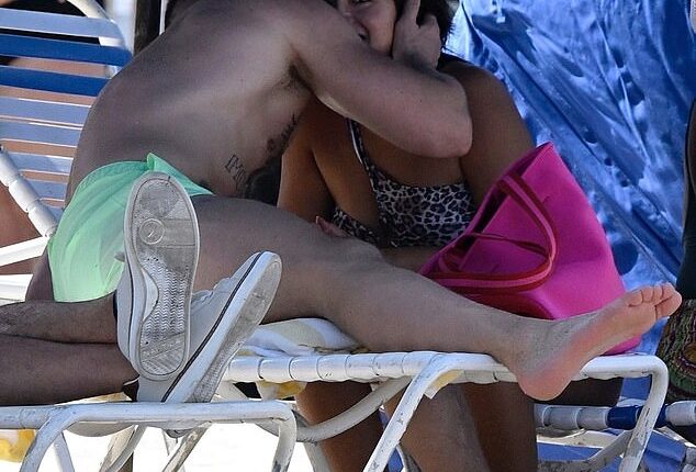 Conor McGregor couldn't keep his hands off of a mystery brunette woman on a busy Florida beach over the weekend as they were pictured kissing