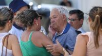 The grandfather of Diogo Jota and Andre Silva is comforted outside the funeral chapel