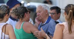 The grandfather of Diogo Jota and Andre Silva is comforted outside the funeral chapel