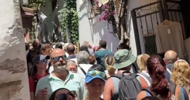 Europe is groaning under a tourism surge. Shocking footage reveal the extent of the crisis, with some streets so crowded that tourists are forced to shuffle shoulder-to-shoulder just to move. Pictured:  A street in Positano, Italy