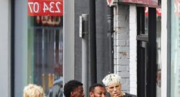 Alejandro Garnacho (right) posed for selfies with fans after getting a haircut on Monday