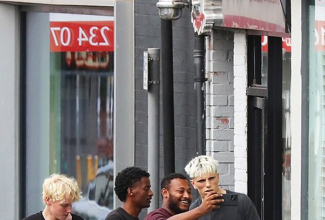 Alejandro Garnacho (right) posed for selfies with fans after getting a haircut on Monday