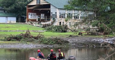 A search and rescue team looks for people along the Guadalupe River near a damaged building at Camp Mystic in Hunt, Texas, on July 7, 2025