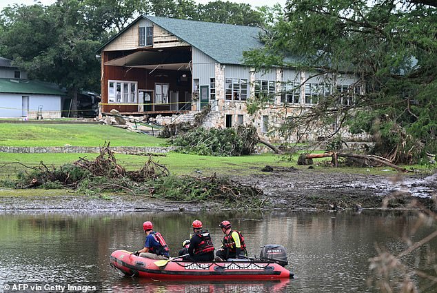 A search and rescue team looks for people along the Guadalupe River near a damaged building at Camp Mystic in Hunt, Texas, on July 7, 2025