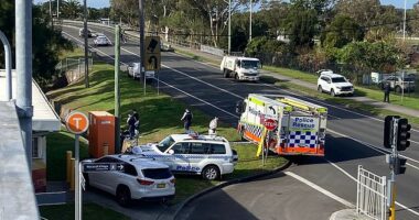 Police are pictured outside Waratah train station in Mayfield on Tuesday morning