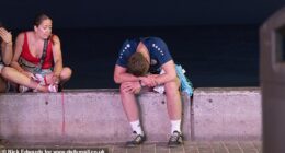 Welcome to the 'German Magaluf', where Deutsch holidaymakers get drunk at the strip's many German beerhalls. A man sits by the beachfront head in hands after a night of heavy drinking