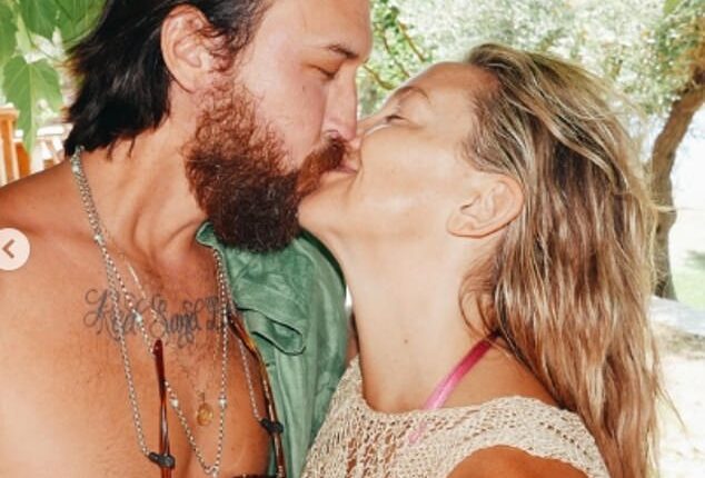 Kate Hudson packed on the PDA with her fiancé Danny Fujikawa as she slipped into a pink bikini in snaps from her Greek family holiday on Instagram on Thursday