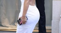 Kim Kardashian was caught googling herself as she brought back the booty in a second block colour latex dress and quirky boots from controversial designer Balenciaga as she arrived for their show in Paris on Wednesday