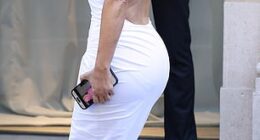 Kim Kardashian was caught googling herself as she brought back the booty in a second block colour latex dress and quirky boots from controversial designer Balenciaga as she arrived for their show in Paris on Wednesday