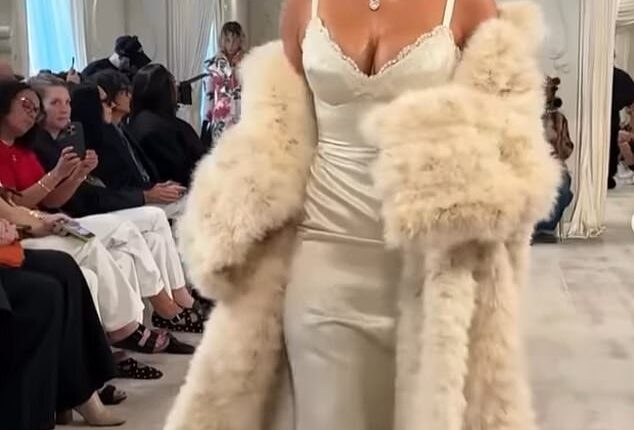 Kim Kardashian is being roundly trolled for her awkward runway walk, with fans sniggering that she looked 'drunk' or 'like a tired toddler'