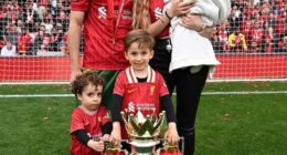 The couple have three children, pictured on the Anfield pitch in May after winning the Premier League