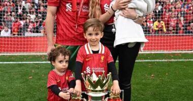The couple have three children, pictured on the Anfield pitch in May after winning the Premier League