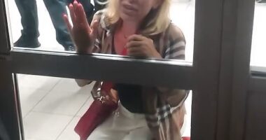 Filmed at Sofia Airport in Bulgaria, the shocking footage (pictured) captures a tearful woman who was brought to her knees in distress as she banged on an airport door while pleading with members of security to allow her onto the aircraft