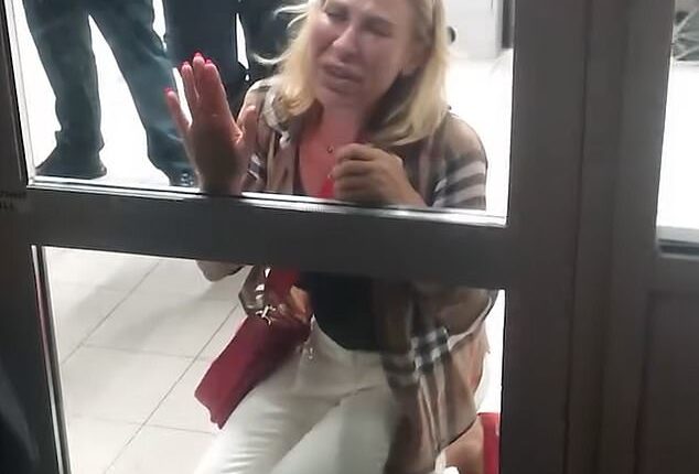 Filmed at Sofia Airport in Bulgaria, the shocking footage (pictured) captures a tearful woman who was brought to her knees in distress as she banged on an airport door while pleading with members of security to allow her onto the aircraft