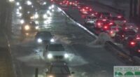 Cars stuck in heavy traffic as the rain battered down and flooded the roads in New York