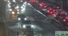 Cars stuck in heavy traffic as the rain battered down and flooded the roads in New York