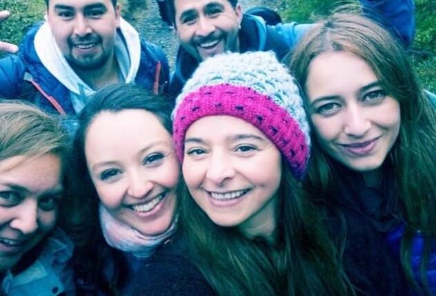 Upon first glance, it may seem as though there are group of six people - four women and two men - who are posing for a selfie while trekking in a forest - but on further inspection, there appears to be a spirit lurking in the picture