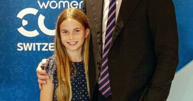 Charlotte has been pictured this afternoon standing close to her father in a sweet blue polka dot dress