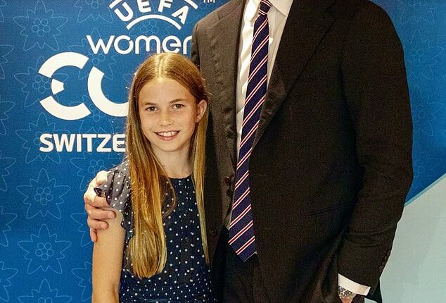 Charlotte has been pictured this afternoon standing close to her father in a sweet blue polka dot dress