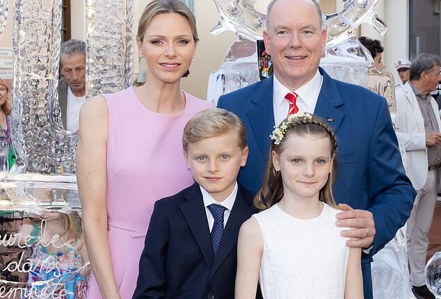 The Prince and Princess of Monaco were spotted beaming alongside their two children during a glorious ceremony to mark the monarch's 20-year reign