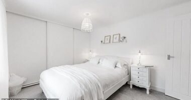One of the two bedrooms emulates the house's interior, with white walls, furniture, bedding and decor