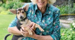 An adorable image of Queen Camilla (pictured) cuddling her rescue dog has been released by the Royal Family , following her trip to Battersea Dogs' and Cats' Home on Monday