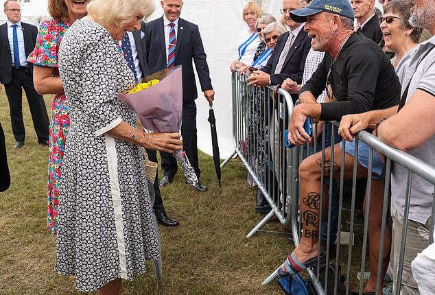 Queen Camilla saw the funny side as she met a royal fan who has had her royal cypher tattooed on his leg