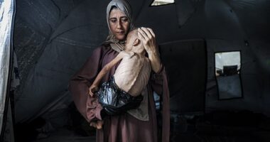 The infant Muhammad is dressed only in a nappy improvised from a bin bag - a result, the photographer says, of the lack of aid flowing into Gaza