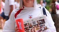 A fan smiles as she awaits the much-anticipated Women's Euro Final in Switzerland