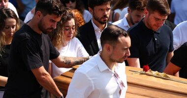 Rute Cardoso helps as pallbearers carry a coffin, at the funeral ceremony of her late husband Liverpool's Portuguese soccer player Diogo Jota and his brother Andre Silva