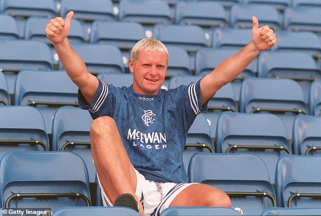 Paul Gascoigne poses in a Rangers shirt after signing from Lazio in July 1995