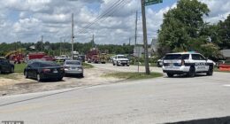 A state trooper has been seriously wounded in a shootout at a major airport before the gunman fled into a church (street outside pictured) during Sunday service