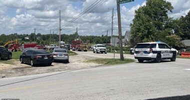 A state trooper has been seriously wounded in a shootout at a major airport before the gunman fled into a church (street outside pictured) during Sunday service