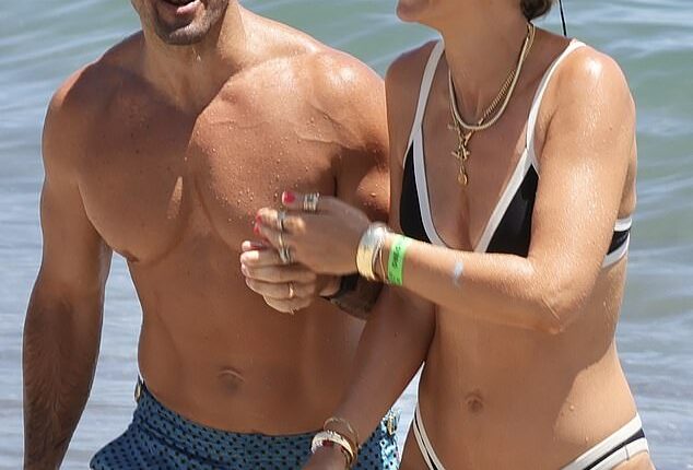 Vogue Williams showed off her incredible figure in a skimpy black and white bikini as she hit the beach in Spain with her family on Sunday