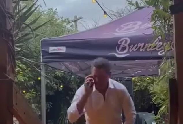 Wayne Carey is pictured in a grab from a viral video that was taken in a trendy Melbourne bar recently. He has furiously blasted claims it shows him and a woman emerging from the bathroom after having a sexual encounter in the toilets