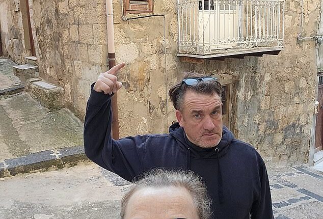 Derbyshire couple Sally Boole, 54, and her husband Martin, 56, outside the house in Mussomeli, Sicily, that they bought for only 1 euro