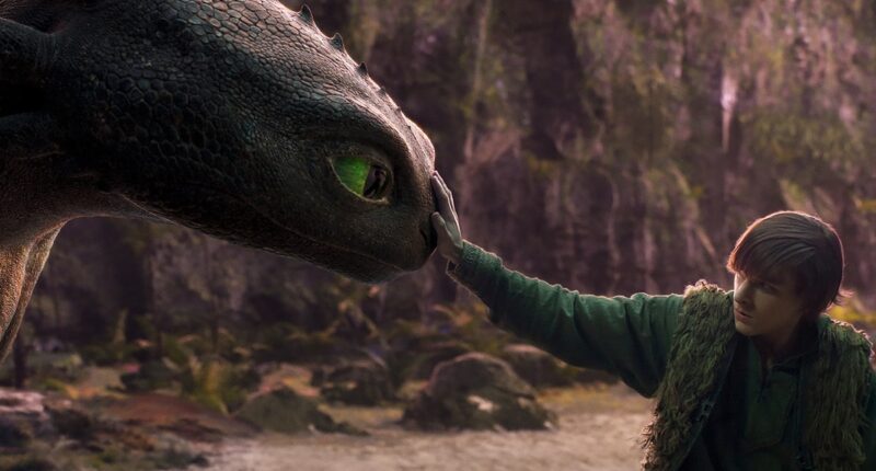 An image from 2025's How to Train Your Dragon with a boy gently booping a dragon's nose.