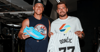 Aaron Judge and Luka Dončić share a pregame moment at Yankee Stadium, exchanging gifts including signed cleats, a game-used bat, and custom jersey.