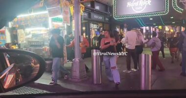People are seen fleeing from the scene of a shooting in Times Square that injured three people in the early hours of Saturday morning
