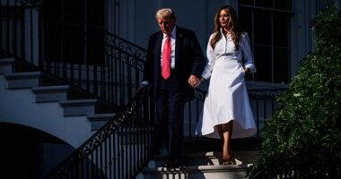 President Donald Trump, joined by first lady Melania Trump, walks down to the driveway after he delivered remarks during an Independence Day military family picnic on the South Lawn of the White House on July 4