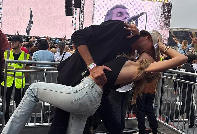 Abbey Clancy and Peter Crouch prove they're still madly in love after 14 years of marriage as they snogged each other's faces off during an Oasis concert