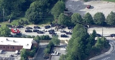 College students at Emory in Georgia, were told to run, hide, or fight following the active shooter alert (Pictured: An aerial view of the massive police presence near the college)