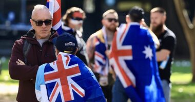 Anti-immigration protests LIVE updates: Moment crowd chants 'Hail Australia' during Sydney rally as protesters are left bloodied by violent clashes in Melbourne and demonstrator flaunts disturbing poster