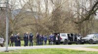 Police near the scene where two police officers were killed and another was wounded at a property near Porepunkah, 300km northeast of Melbourne