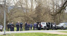 Police near the scene where two police officers were killed and another was wounded at a property near Porepunkah, 300km northeast of Melbourne