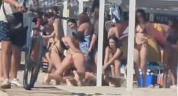 A beach brawl broke out in war-ravaged Odesa when two bikini-clad women clashed and wrestled each other