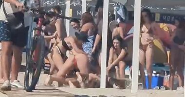 A beach brawl broke out in war-ravaged Odesa when two bikini-clad women clashed and wrestled each other