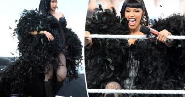 Cardi B hosts WWE SummerSlam in a yards-long feathered cape and corset