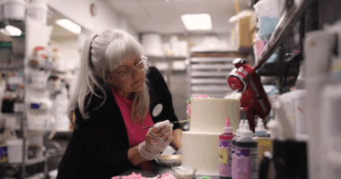 Cathy Miller decorating a cake.