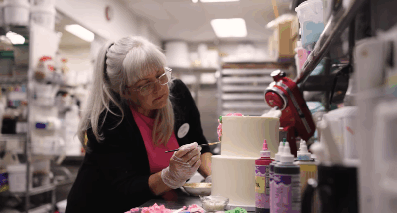 Cathy Miller decorating a cake.